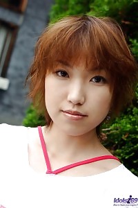 Asian chick in red gets off her underwear and displays her exciting breasts and twat