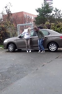 2 gfs piss behind a parked vehicle