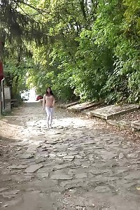 Black haired pretty squats outside and pisses
