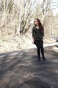 Redheaded in glasses squats to pee outdoor