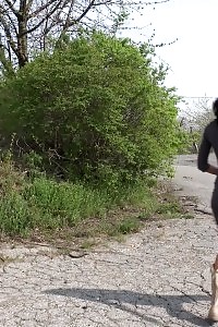 Dark haired Eveline Neill squats and taking a leek outdoors