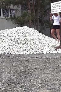Good-looking nag pisses onto a pile of rubble