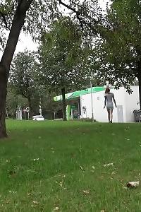 Inked covered chick pisses outside on grass