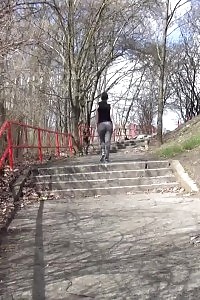 Brunette doll pisses on concrete steps
