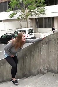 Magnificent brunette pisses in the middle of the city