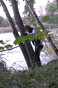 Brunette vixen pissing against passing traffic
