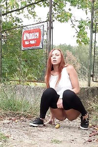 Ginger in pants pissing outside