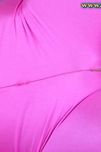 delicious black angel Lisa posing in green bra and pink latex pants on the couch