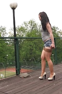 Good-looking lassie in miniskirt and nylons pees outside