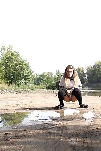 Brunette lass keeps a lookout while peeing