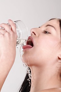 Dark haired Doroty toys her piss soaked pussy
