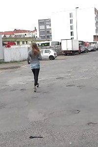 Big-breasted brunette taking a leek behind a bus