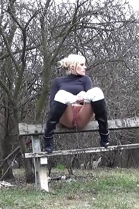 Amazing darling pisses while on a park bench