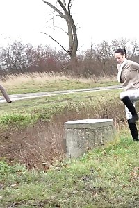 Black haired hottie relieves herself in public