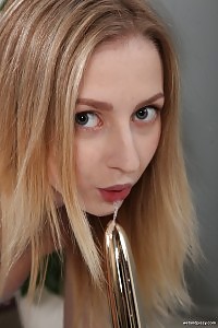 Petite blonde sips her golden piss from a cup