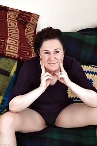 brunette Xiomara demonstrates her black panties as she sits on the table