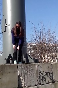 Black-haired with long hair pisses in public view