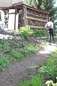 Black haired Esperansa pees into a forest stream