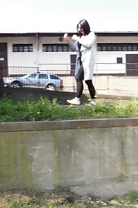 Black haired gal sprinkles her pee off a ledge