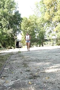 Divine girl in flip flops pisses on the ground