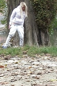 Good-looking blonde pissing twice while being shot