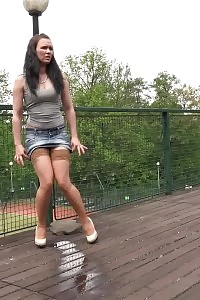Good-looking lassie in miniskirt and nylons pees outside