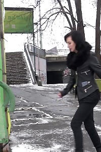 Good-looking black haired babe melts snow as she pissing