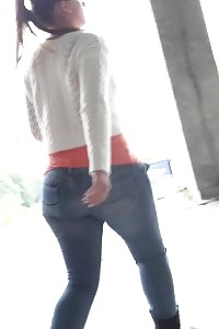 Black-haired bitch in white sweater pisses public