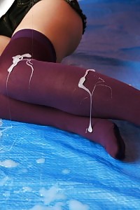 Playful Asian nurse in sexy high nylons has her leg covered in sperm