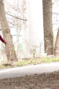 Desirable doll pees on stones outside