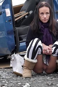 Eveline squats behind an abandoned vehicle to pee