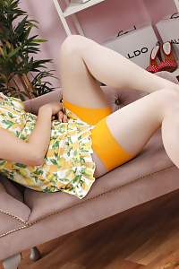 Sultry siren Harper wearing nothing but her black stockings, and beige panties, posing seductively on the table