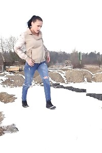 Magnificent girl squats in the snow and pisses outside