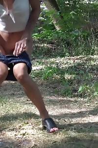 Divine doll squats to piss next to a road on ground