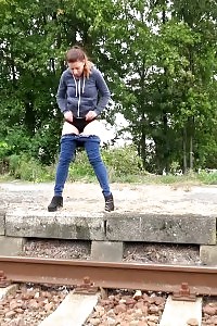 Bootylicious brunette pisses over the train tracks