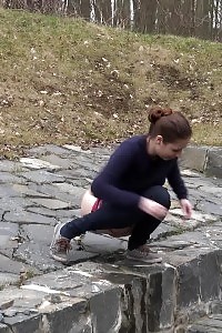 Antonia pissing outside next to drainage pipe