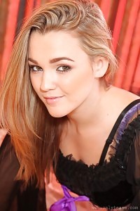 Intriguing, big-breasted blonde strips out of her cosplay costume and looks a tease in her lilac undie and black nylons.