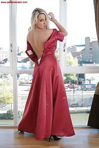 Sexy belle Hazel merrily poses indoor as she pulls down her red sexy dress