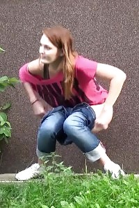 Red-haired squats right down to pee