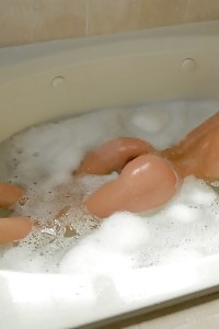 Taking a bubble bath nude